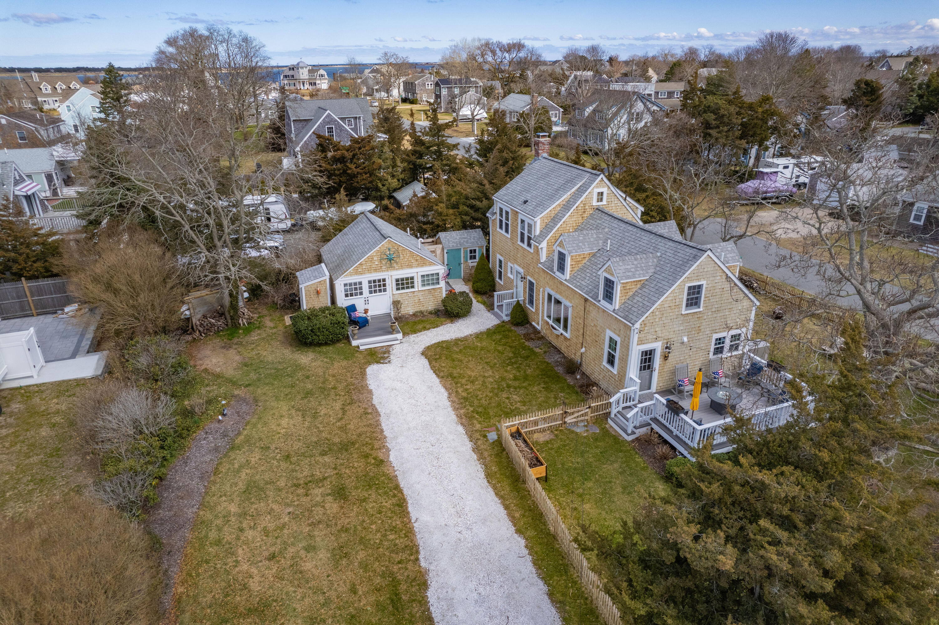 40 Commerce Road Barnstable, MA 02630 - Photo 3 of 43 an aerial view of a house with a yard