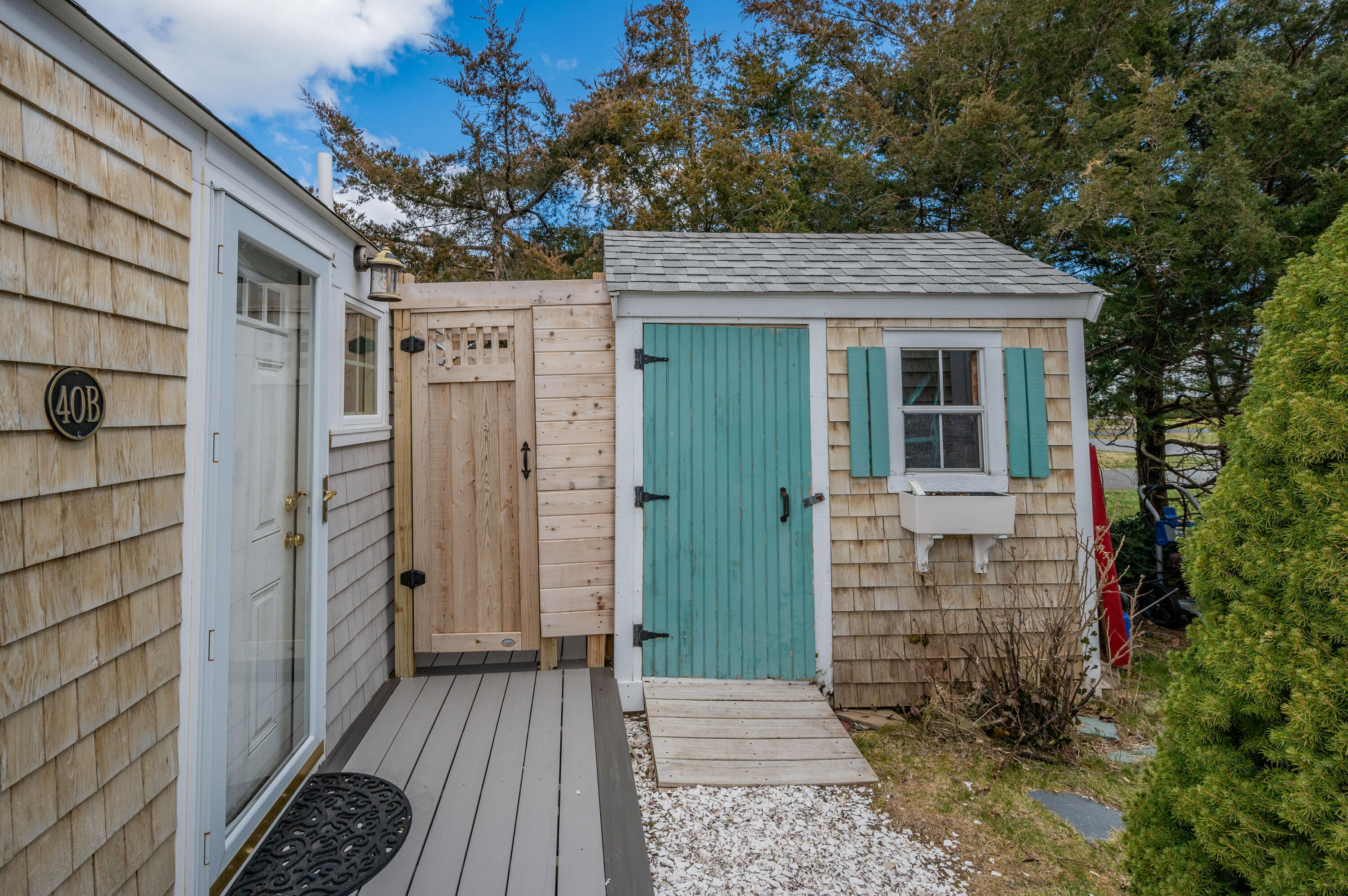 40 Commerce Road Barnstable, MA 02630 - Photo 33 of 43 a view of a pathway of a house with wooden fence