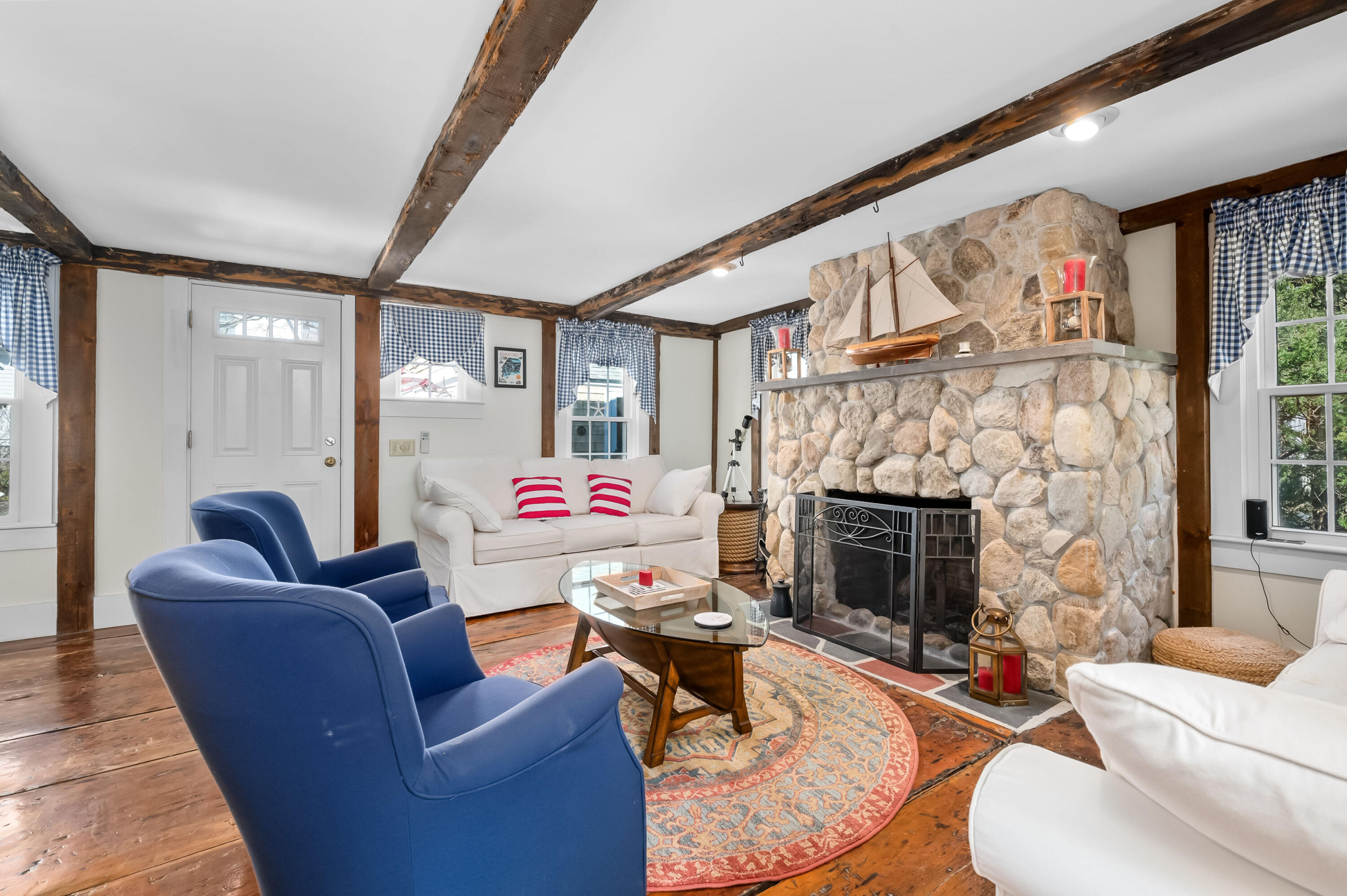 40 Commerce Road Barnstable, MA 02630 - Photo 4 of 43 a living room with furniture and a fireplace