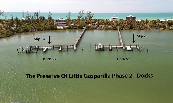 a view of a lake with lawn chairs