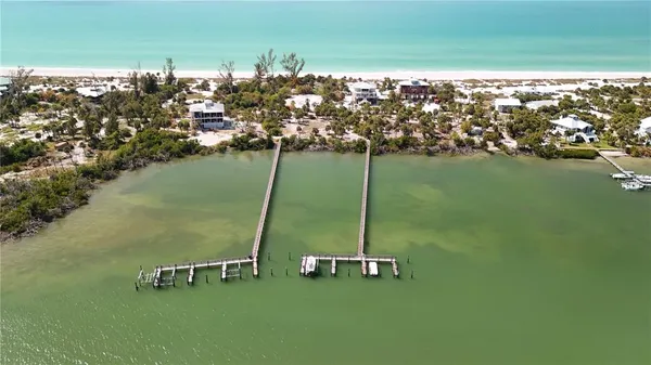an aerial view of a houses with ocean view