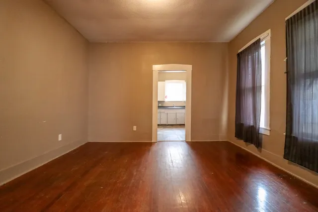 a view of a livingroom with wooden floor and a window