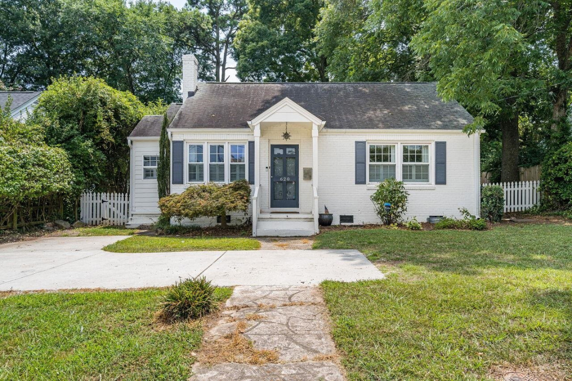 620 East Whitaker Mill Road Raleigh, NC 27608 - Photo 1 of 28 a front view of a house with a yard and garage