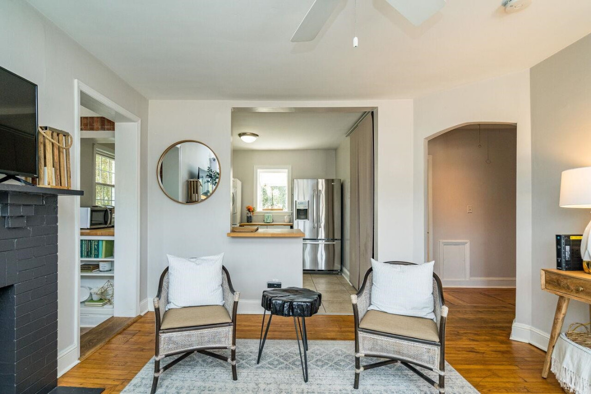 620 East Whitaker Mill Road Raleigh, NC 27608 - Photo 6 of 28 a living room with furniture a rug and a flat screen tv
