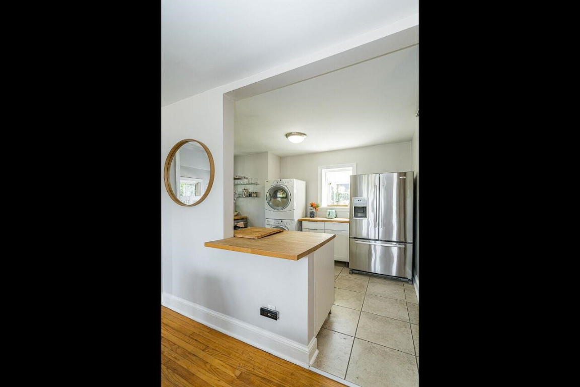 620 East Whitaker Mill Road Raleigh, NC 27608 - Photo 10 of 28 a bathroom with a sink mirror vanity and a toilet