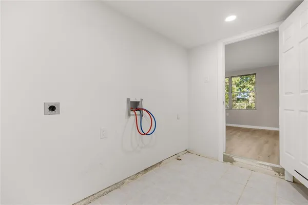 a bathroom with a glass shower door and a window
