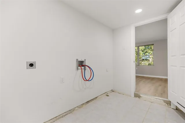 a bathroom with a glass shower door and a window