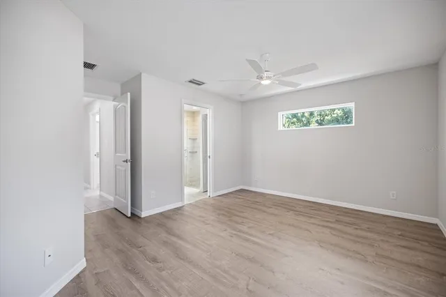 a view of an empty room with wooden floor