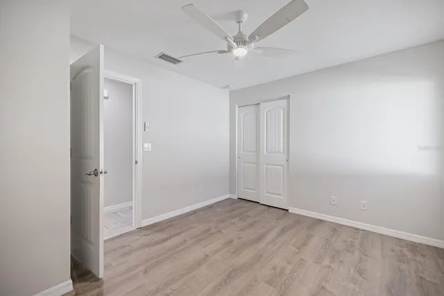 a bathroom with a granite countertop sink a toilet and mirror