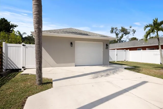 a view of an house with backyard and a tree