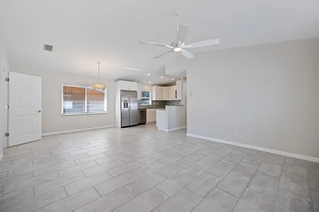 an empty room with closet and windows