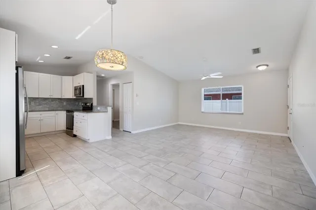 a kitchen with stainless steel appliances granite countertop a sink dishwasher stove and oven with granite countertops