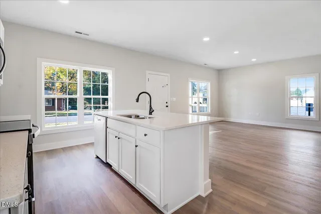 a kitchen with sink cabinets and wooden floor