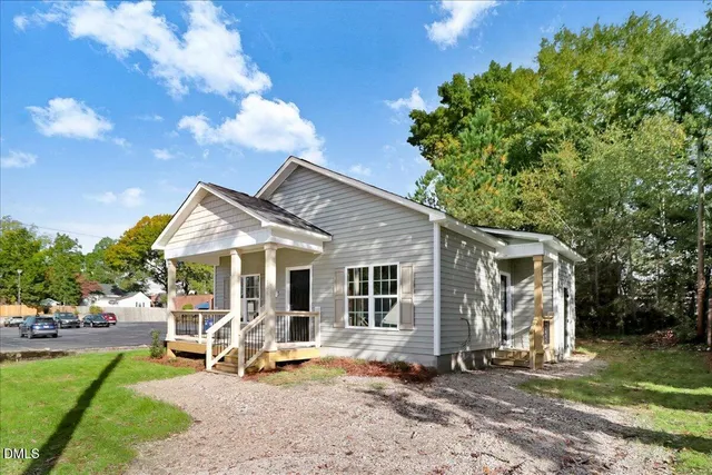a view of a house with backyard porch and sitting area