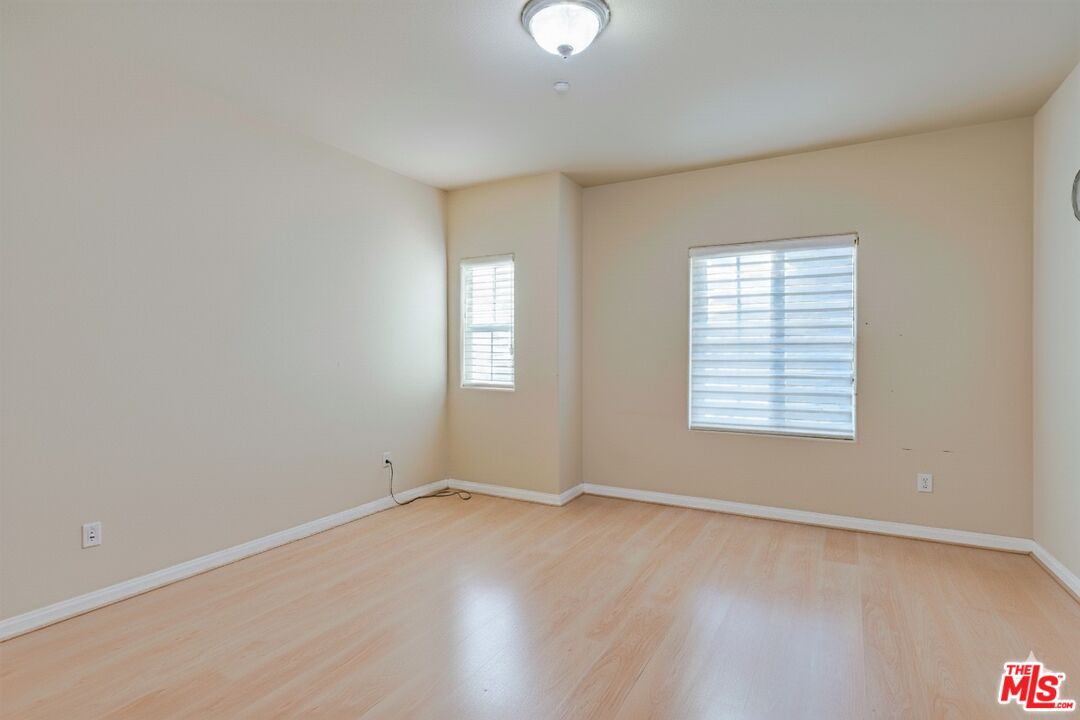 2155 Associated Road Fullerton, CA 92831 - Photo 14 of 47 an empty room with wooden floor and windows