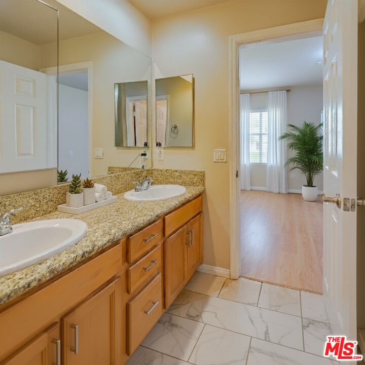 2155 Associated Road Fullerton, CA 92831 - Photo 16 of 47 a bathroom with a granite countertop sink and a mirror