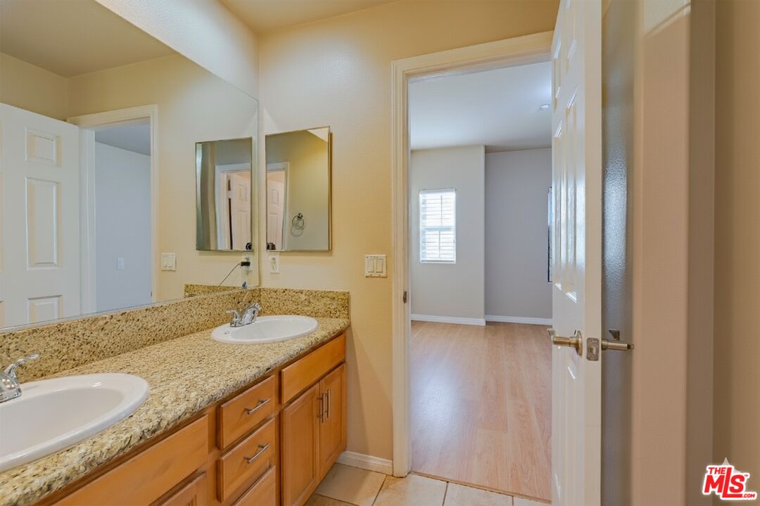 2155 Associated Road Fullerton, CA 92831 - Photo 17 of 47 a bathroom with a granite countertop sink and a mirror
