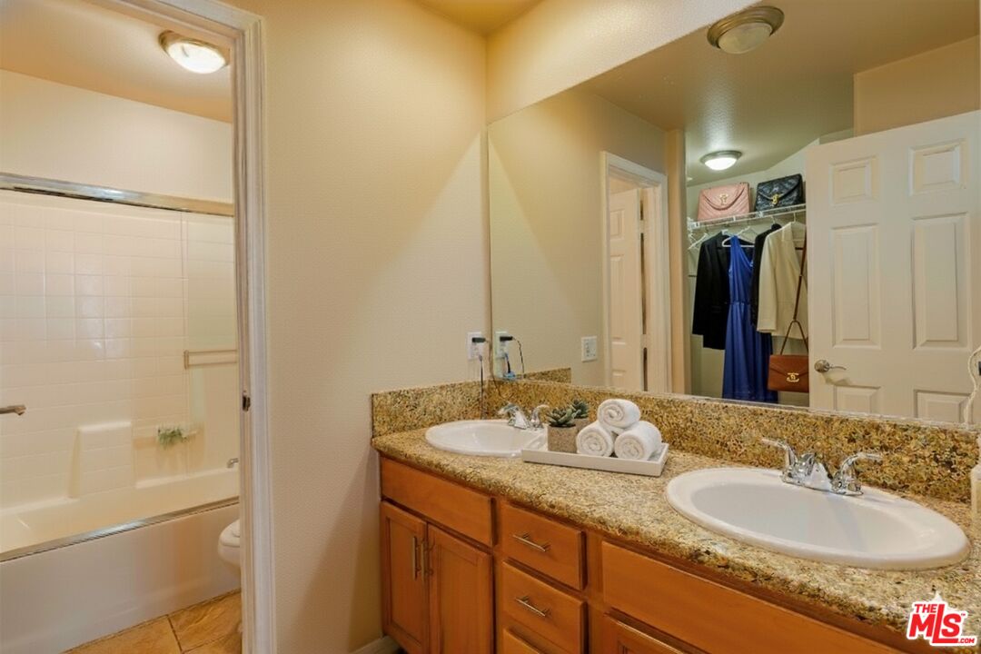 2155 Associated Road Fullerton, CA 92831 - Photo 18 of 47 a bathroom with a granite countertop sink and a mirror
