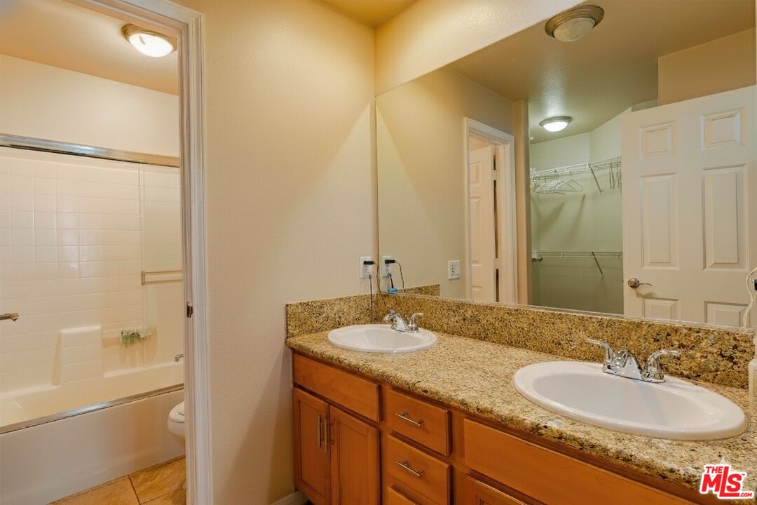 2155 Associated Road Fullerton, CA 92831 - Photo 19 of 47 a bathroom with a granite countertop sink and a mirror