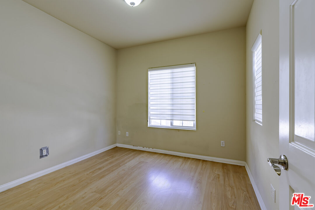 2155 Associated Road Fullerton, CA 92831 - Photo 28 of 47 an empty room with wooden floor and windows