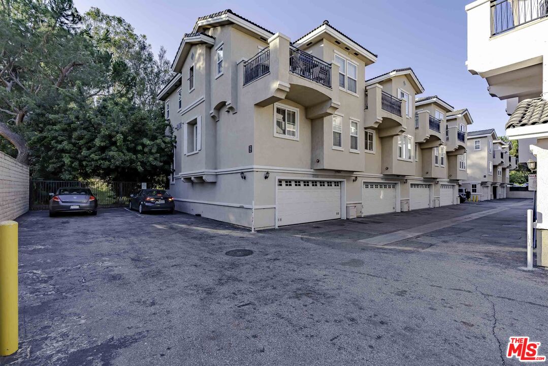 2155 Associated Road Fullerton, CA 92831 - Photo 34 of 47 a view of a white house with large trees