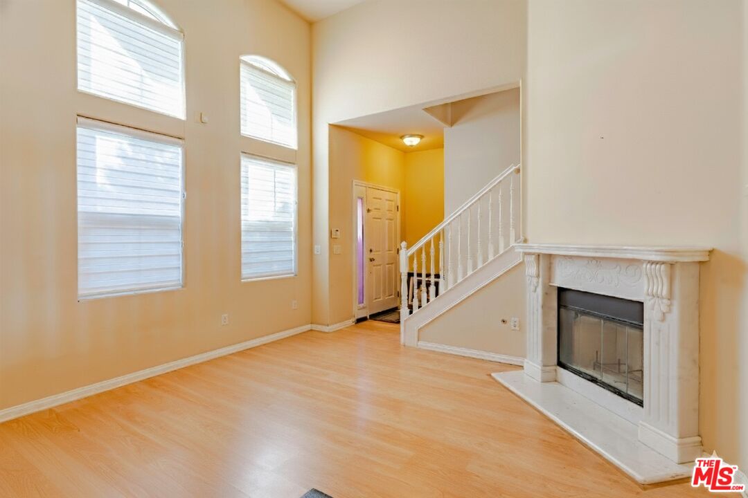 2155 Associated Road Fullerton, CA 92831 - Photo 4 of 47 a view of an empty room with wooden floor and a window