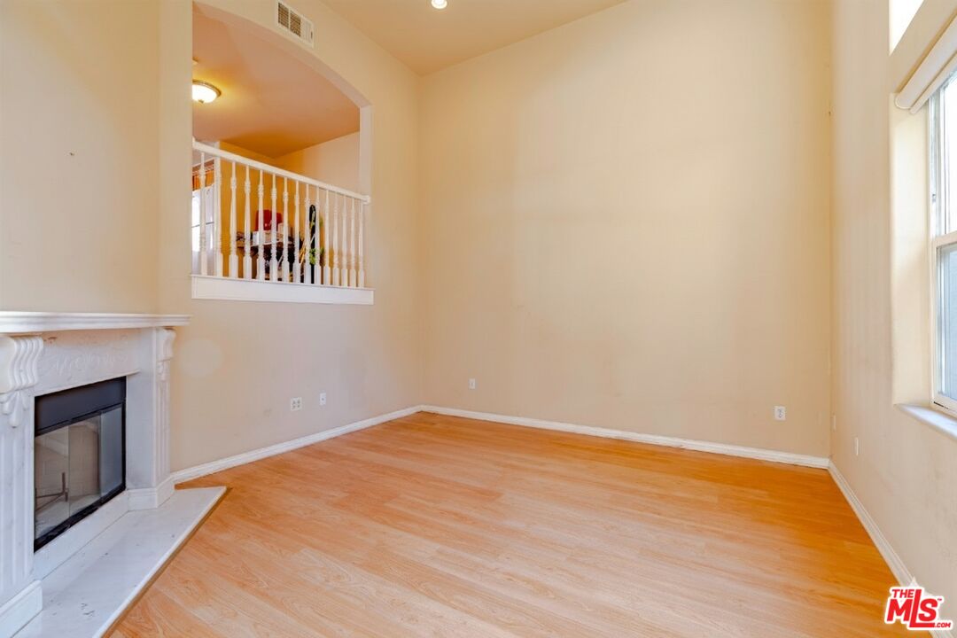 2155 Associated Road Fullerton, CA 92831 - Photo 7 of 47 a view of an empty room with wooden floor and a window