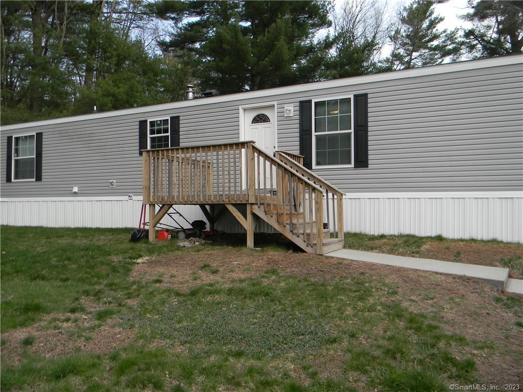 81 R And R Park Dayville, CT 06241 - Photo 1 of 1 a view of a house with a yard and deck