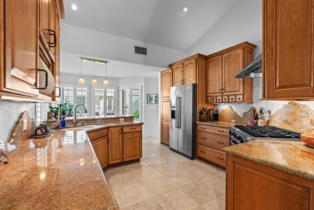 a kitchen with refrigerator and cabinets