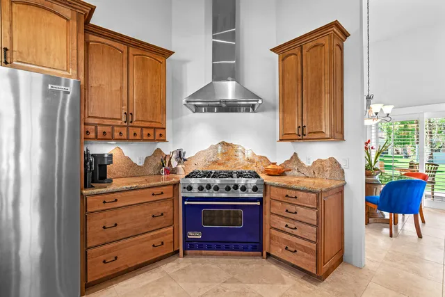 a kitchen with stainless steel appliances granite countertop a stove and a cabinet