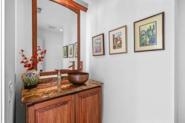 a bath room with a sink and a mirror