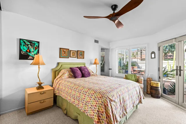 a bedroom with bed and glass door