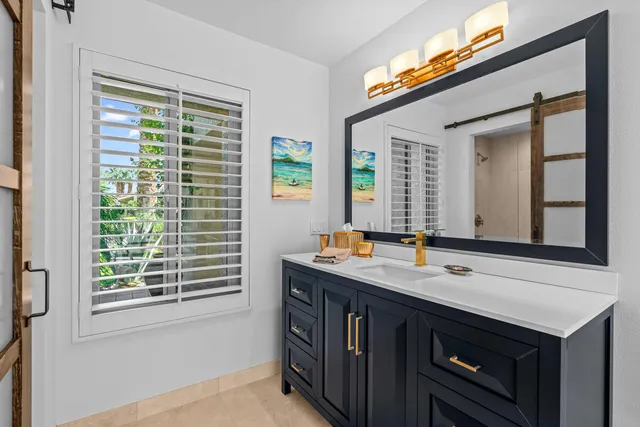 a bathroom with a sink a vanity and a mirror