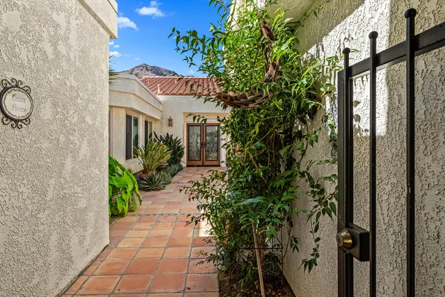 front view of a house with a fountain and a potted plant