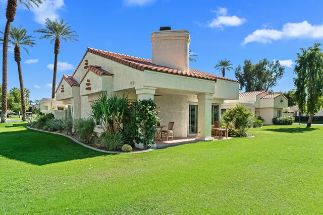 a view of a house with backyard porch and sitting area