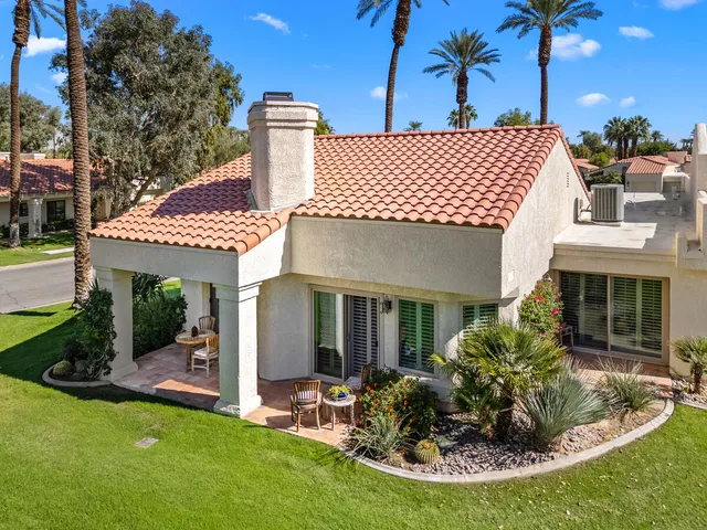 an aerial view of a house with garden space and street view