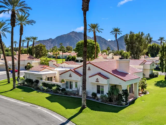 a view of a chair and table in front of a house