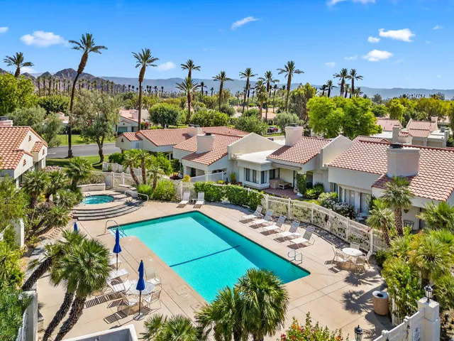 a view of a backyard with a patio and fire pit