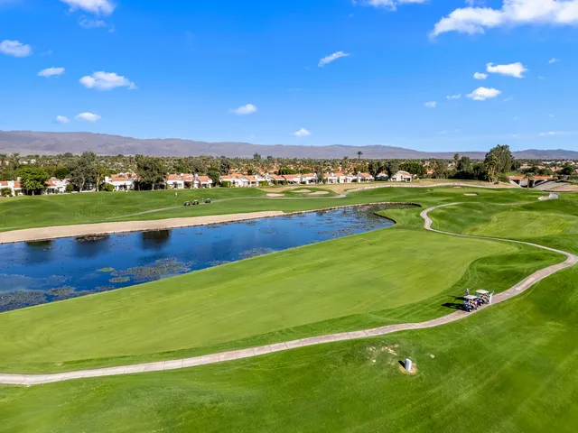a view of a field with mountains in the background