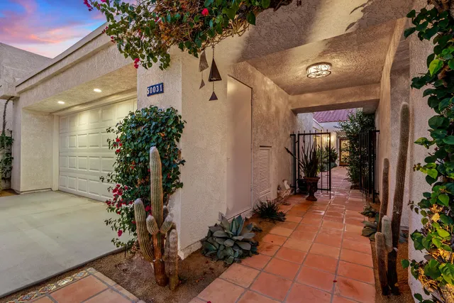 a lobby with furniture and potted plants