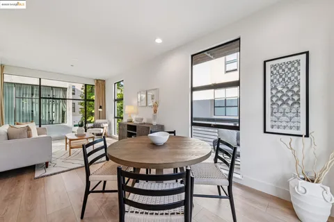 a dining room with furniture and wooden floor