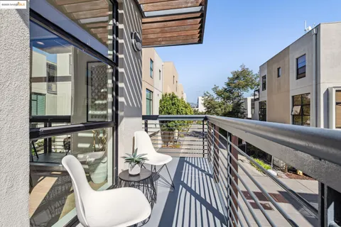 a balcony view with couple of chairs