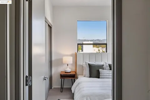 a bedroom with a bed and large window