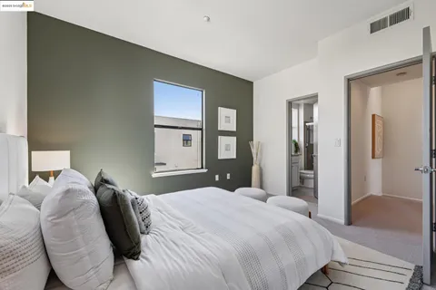 a bedroom with a bed and a large mirror