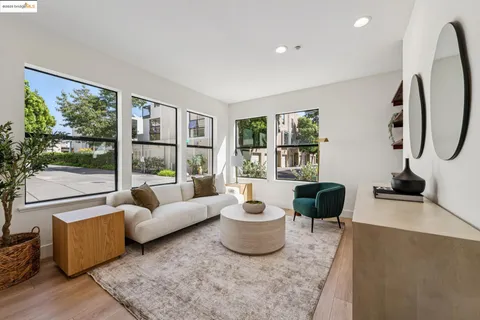 a living room with furniture and a floor to ceiling window
