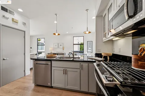 a kitchen with a sink stove and cabinets