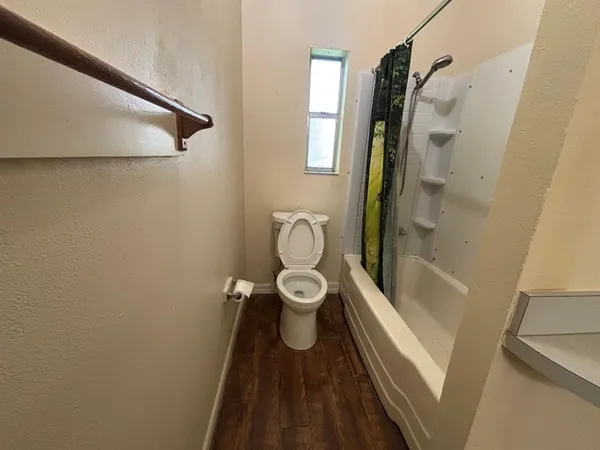 a bathroom with a toilet and a shower