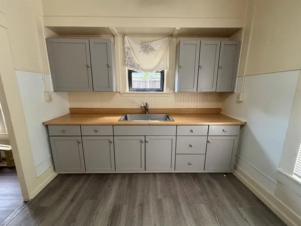 a kitchen with sink cabinets and window