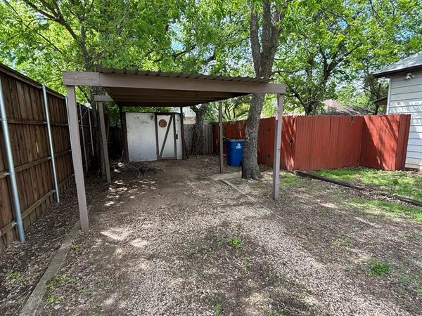 a view of a backyard with a sink and wooden fence