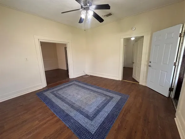 a view of an empty room and wooden floor
